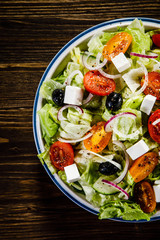 Greek salad on wooden background
