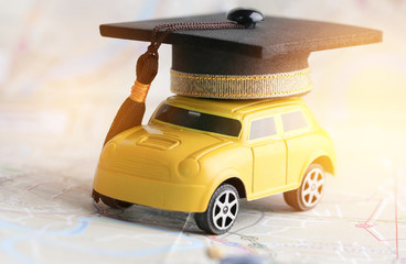 Graduate study abroad inter school concept : Graduation cap over yellow car on Bangkok city map,...