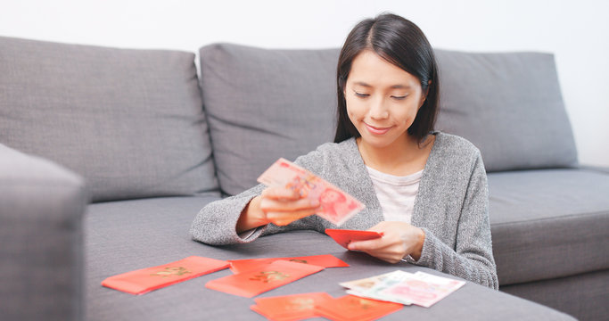 Woman putting money into chinese red packet