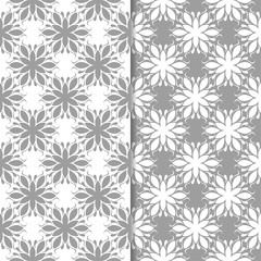 White and gray floral backgrounds. Set of seamless patterns