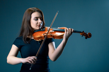 Woman with violin on blue grey background