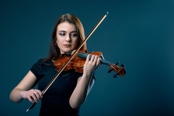 Woman with violin on blue grey background