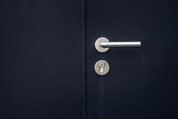 Naklejka premium Close up keys lock in black door