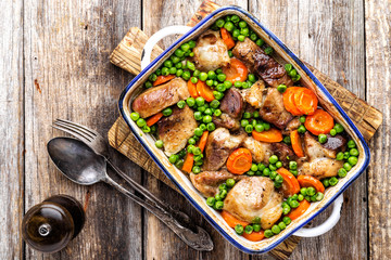 Meat baked with carrot and green peas