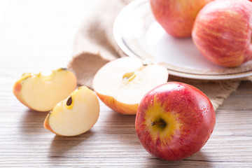 Fresh red apple and slices on wooden table. Closeup