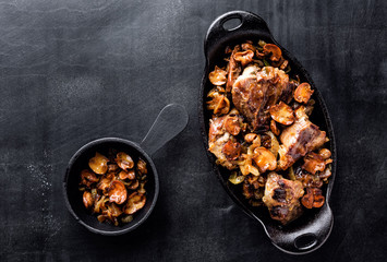 meat baked with mushrooms and onions in cast iron dish