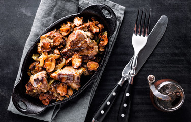 meat baked with mushrooms and onions in cast iron dish