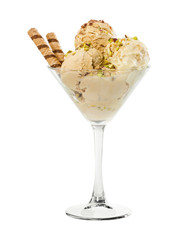 Creme brulee ice cream with nuts and wafer stick in glass vase