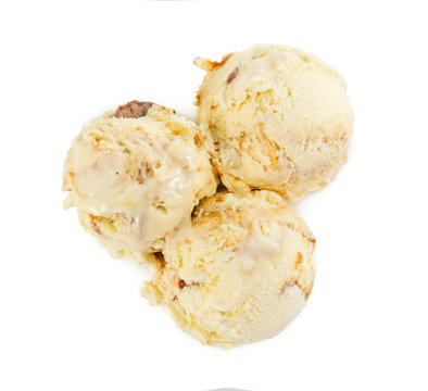 Three balls of vanilla ice cream with caramel. Top view.