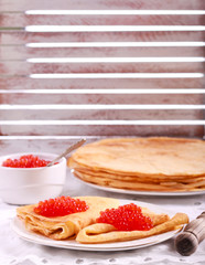 Thin pancakes with red caviar