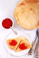 Thin pancakes with red caviar