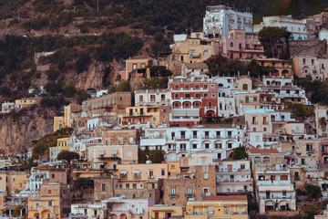 Fototapeta premium Positano Italy landscape blue sea background, colorful flowers, cloudy sky little village romantic atmosphere nature sunlight sunrise and sunset path of gods Amalfi coast view panorama