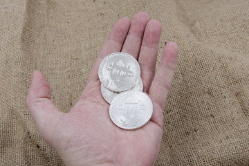 Bitcoins on a hand with wooden background