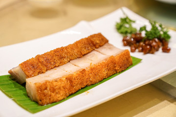 Pork crispy hong kong chinese style on white dish in chinese food restaurant