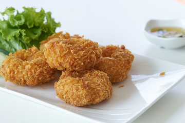 fried shrimp with flour pancake on plate in restaurant, on white background, Thai food.