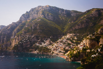 Positano Italy landscape blue sea background, colorful flowers, cloudy sky little village romantic...