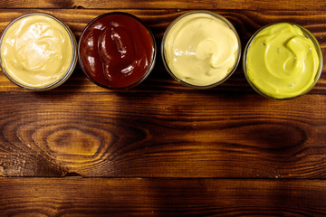 Set of sauces on wooden table
