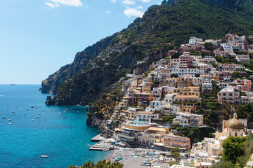 Naklejka premium Positano Italy landscape blue sea background, colorful flowers, cloudy sky little village romantic atmosphere nature sunlight sunrise and sunset path of gods Amalfi coast view panorama
