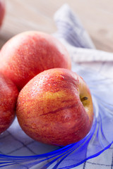 Closeup of fresh red apples on a plate