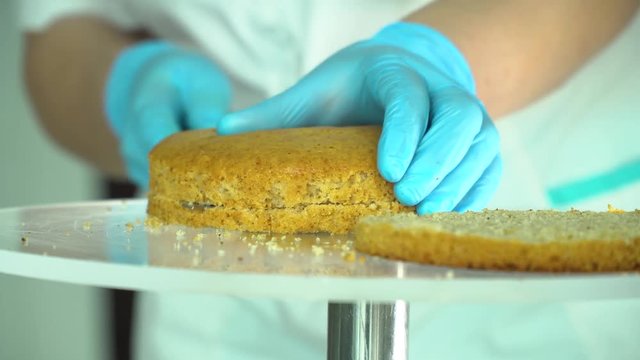 confectioner cuts cake into layers