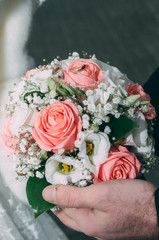 wedding rings with pastel pink rose
