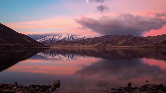 Deer Creek Reservoir reflecting colorful time lapse sunrise with cloudy sky