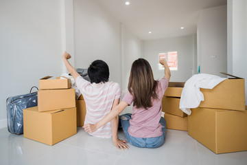 Young asian couple moving into new home