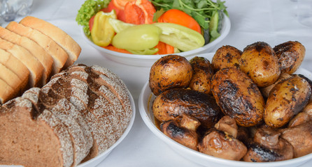 picnic, bread, fresh vegetables and grilled mushrooms and potatoes