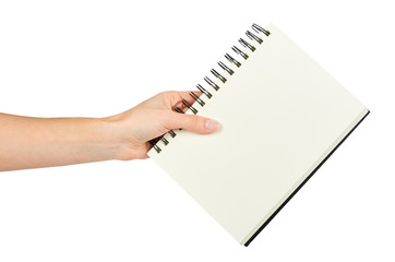 Open black notebook for writing or drawing on spiral in hand, isolated on white background