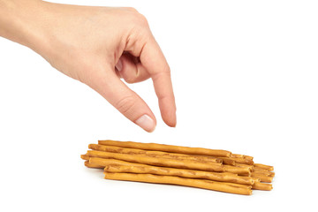 Homemade salty backed pretzel sticks in hand, isolated on white background