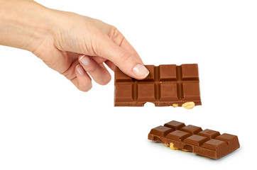 Homemade chocolate bar with whole nuts in hand. Isolated on white background