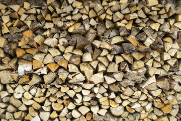 Carefully stacked tidy full frame split log pile background texture