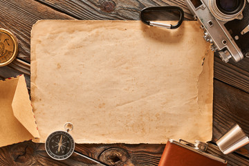 Old blank paper sheet and vintage 35mm camera