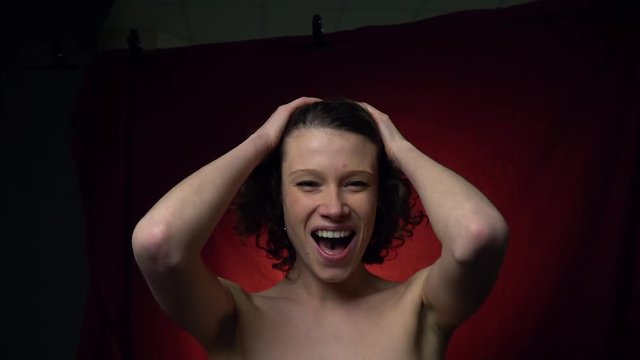 Woman with tongue piercing screams from orgasm, slow motion