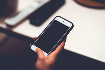 woman holding an smartphone in her hand in vintage colors