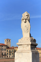 Fototapeta na wymiar Lion statue on the entrance of Ponte Solferino, a bridge on the Arno river in Pisa, Italy