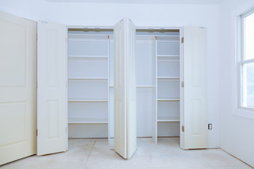 With a shelf near of big cabinet. Furniture installation.