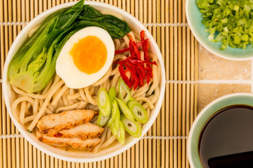 Japanese Style Chicken and Udon Noodle Broth or Soup With Pak Choi And Red Chillies