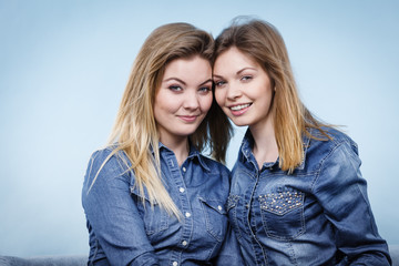Two happy women friends wearing jeans outfit