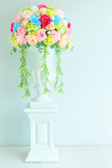 colorful fabric roses bouquet  in vase at wedding reception for background decorated on the wall.