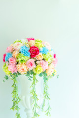 Beautiful rose from fabric colorful flower decoration  with the green wall in a wedding reception