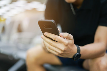 close up young man hand playing on smartphone touch screen for using application concept.