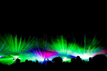 Colorful laser show nightlife club stage with smartphone filming. Luxury entertainment with...