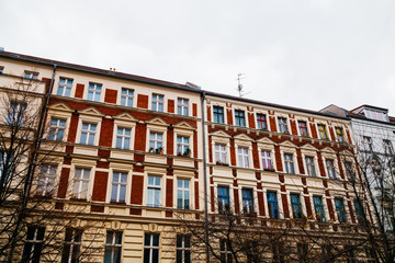 Fototapeta premium Vintage style apartment buildings with red facade