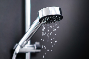 Turning off or on running water in shower. Last or first drops splash from faucet. Water...
