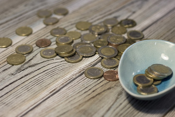 Coins on the table. Rough boards background. Money concept. Closeup