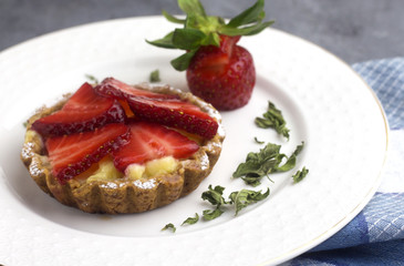 delicious homemade arabic strawberry tartlet on white plate