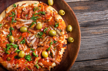 pizza with olives on a wooden table