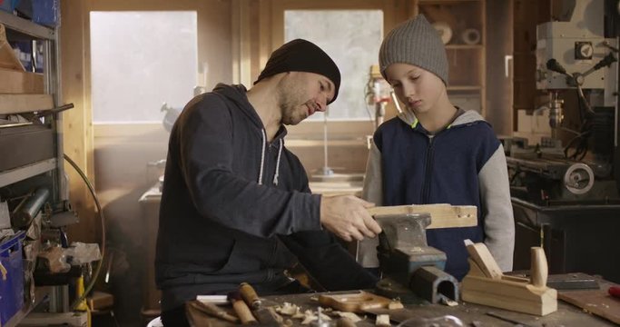 Father teaching his son some craftsmen techniques