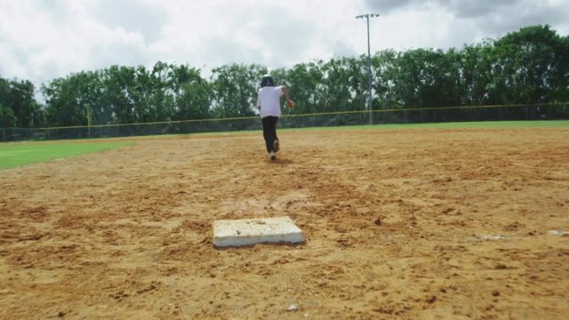 Slow Motion of kid running from first base to second base at empty baseball park